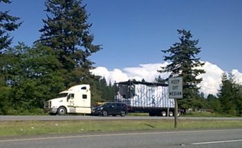 oversize load suspected of striking overpass