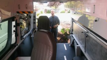 ryan showing the interior of a recently completed red cross erv