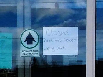 closed due to power outage handwritten sign in business door