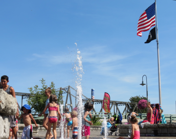 fountain with kids playing at Centennial Riverwalk Park