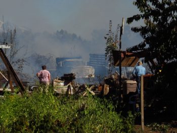 neighbors-using-garden-hoses-to-protect-their-property-during-field-fire-1800-harksell-rd