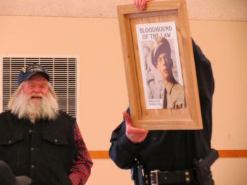 chief-knapp-holds-up-a-present-from-the-board-members-of-the-ferndale-food-bank