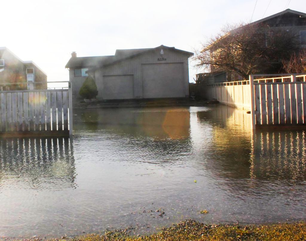 Strong surf causes property and road flooding in Sandy Point (December 4, 2016). Photo courtesy of Sandy Point Watch