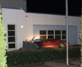 car crash on windward hs campus - car sets between hedge and building