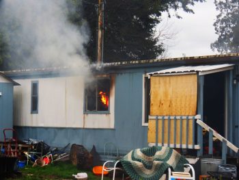 Flames are visible from the interior of a mobile home fire 6100 blk Portal Way 2017-04-13