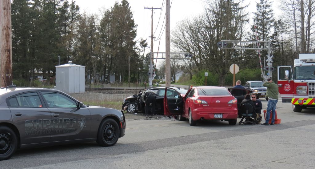 North Whatcom Fire and Rescue crews assess and treat a vehicle crash victim while deputy kevin McFadden talks with the driver of the other vehicle 2017-04-11