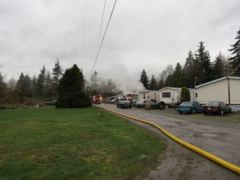 WCFD7 water lines stretch from Portal Way to the rear of a trailer park to knock down a mobile home fire 2017-04-13