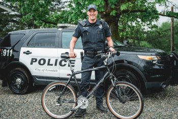 Sergeant Travis Card poses with his two patrol vehicles including a bicycle photo FPD