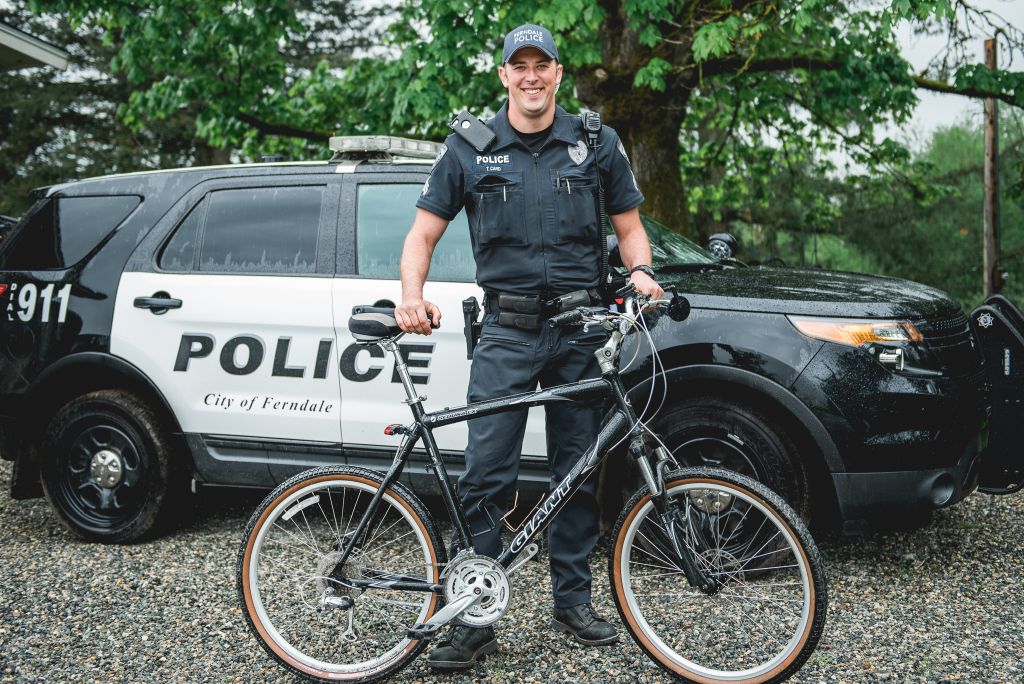 Sergeant Travis Card poses with his two patrol vehicles including a bicycle photo FPD