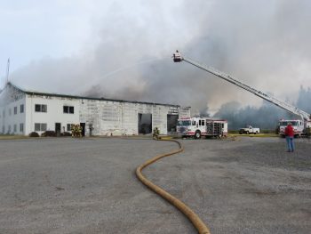 Firefighters continued to knock back the fire that destroyed the building that housed Friberg Construction (June 17, 2017). Photo: Discover Ferndale