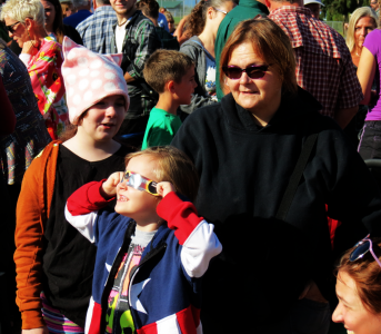 Girl tries out eclipse glasses during community viewing event 2017-08-21