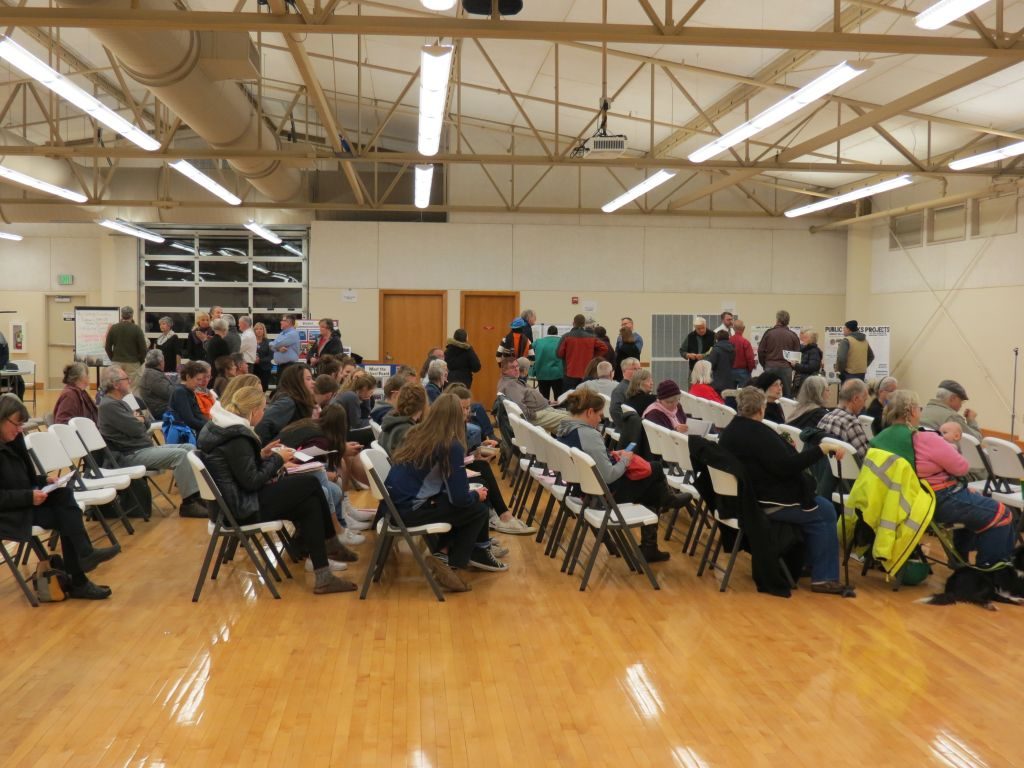 Audience of about 100 prepares to hear presentations