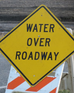 water over roadway sign