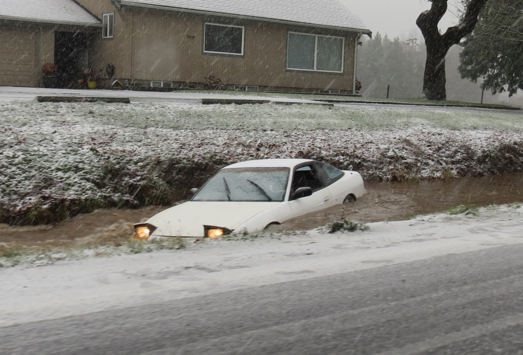 Empty vehicle in fast flowing ditch alongside Portal Way south of Grandview Rd 2017-12-19
