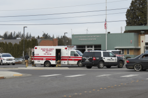 Aid crews and police assess a teenager who reportedly fell from a moving vehicle on Washington Street 2018-02-09