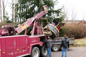 berk's towing employees work to return a toppled 'mini excavator' to its trailer after it collided with the bnsf bridge over main street 2018-02-21