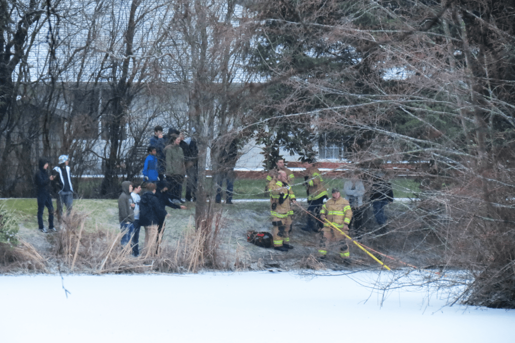 neighbors watch as wcfd7 crews rescue a stranded young man from an island in a neighborhood pond 2018-02-21