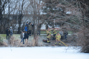 neighbors watch as wcfd7 crews rescue a stranded young man from an island in a neighborhood pond 2018-02-21