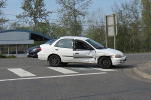 A white compact car involved in a crash in the 1700 block of Main Street sustained damage on the passenger side (April 27, 2018). Photo: Discover Ferndale