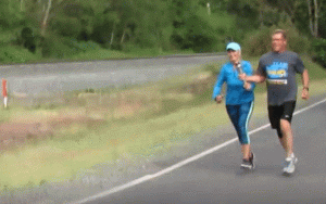Ferndale Police Officer Mike Catrain and his wife, Chris, hand off the Special Olympics torch to a Bellingham Police officer on Portal Way at Brown Road (May 30, 2018). Photo: Whatcom News