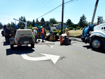 public work crews work is rewarded as lifting the road surface reveals a water break20118-07-15