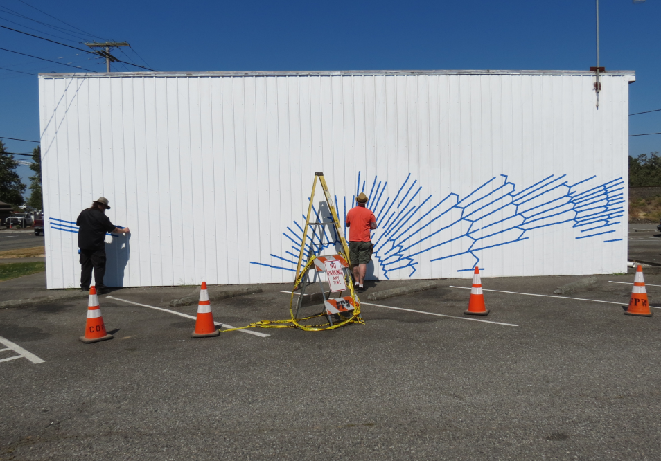 FAC member kyle deming and artist todd bruce begin laying out the pattern for a mural on the city hall annex 2 20118-08-09