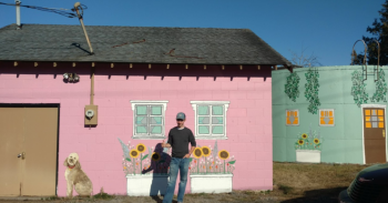 guyan cool poses in front of water tank and pump house murals 2018-09-02 src colleen harper