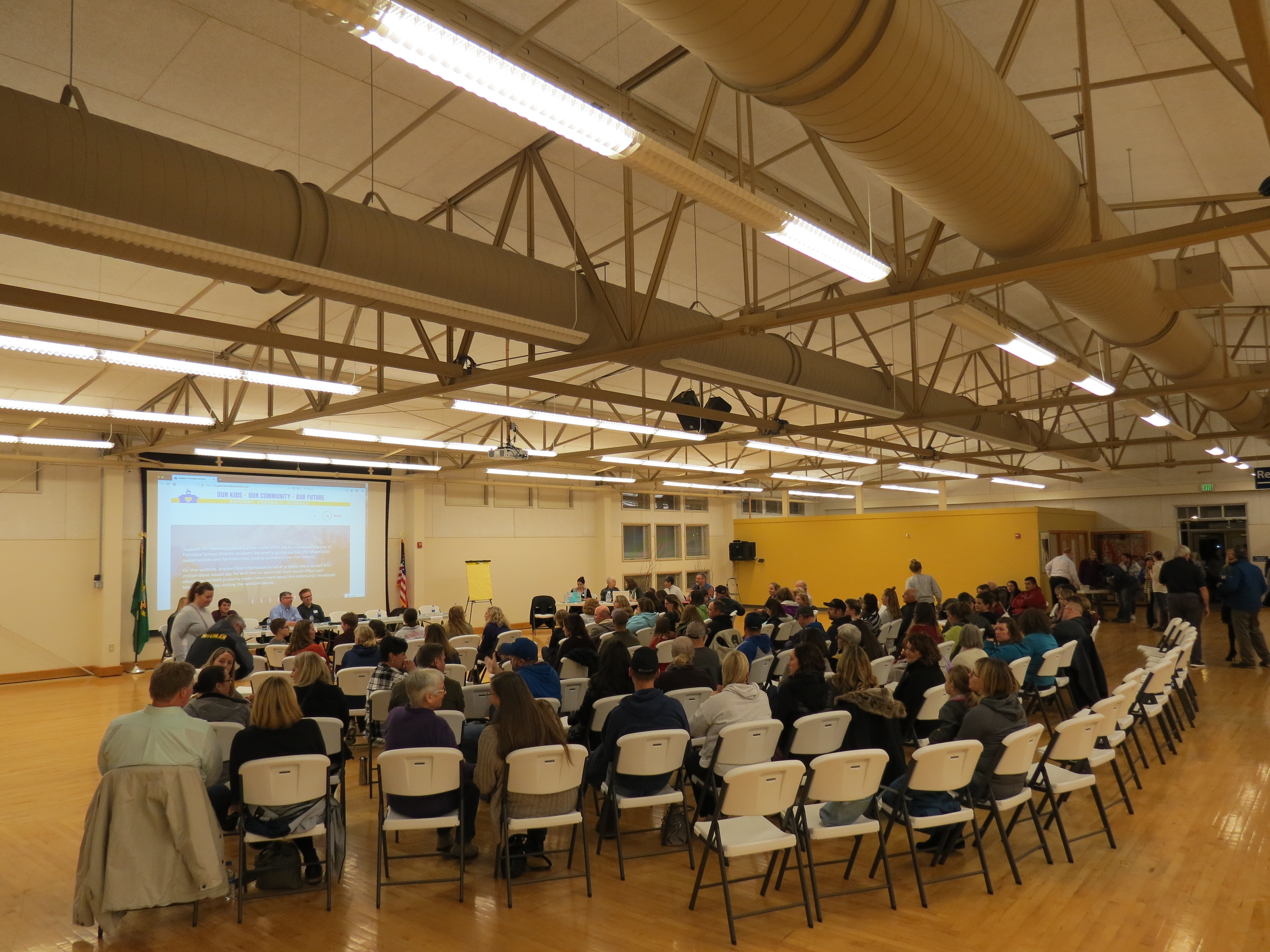panel members and attendees take their seats just prior to a school bond town hall meeting 2018-11-15