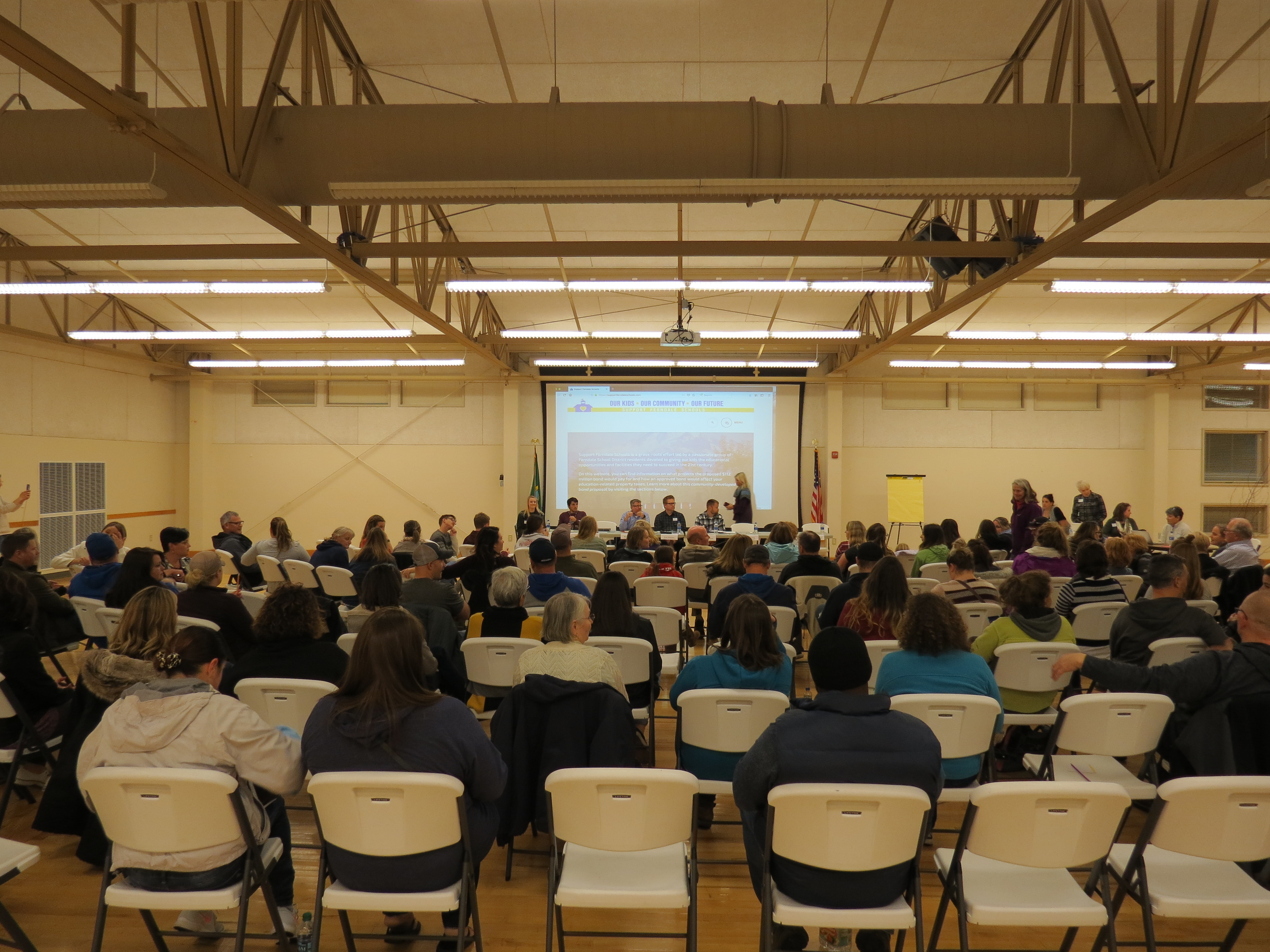 panel members and attendees take their seats just prior to a school bond town hall meeting 2018-11-15