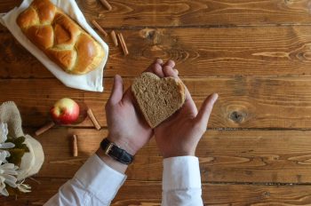 person holding heart shaped bread