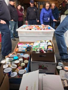 Whatcom 7 Firefighters and Ferndale Food Bank Executive Director Suzanne Nevan work to receive of 5,000 pounds of community donations (December 19, 2018). Photo courtesy of Whatcom 7 Firefighters