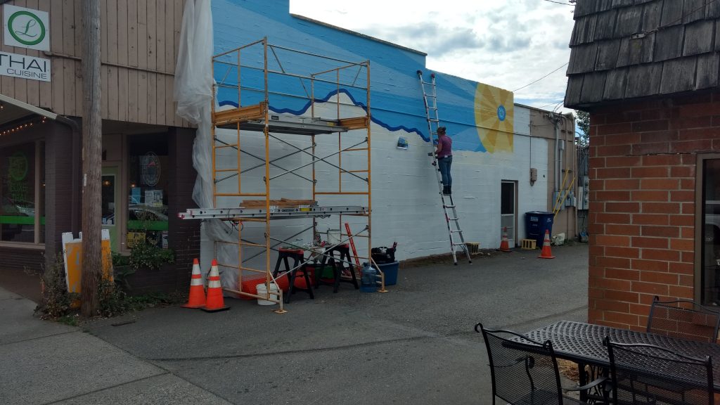 Brenda Goddard-Laurence at work on a mural in an alley on 3rd Avenue in Ferndale (June 12, 2019). Photo: My Ferndale News