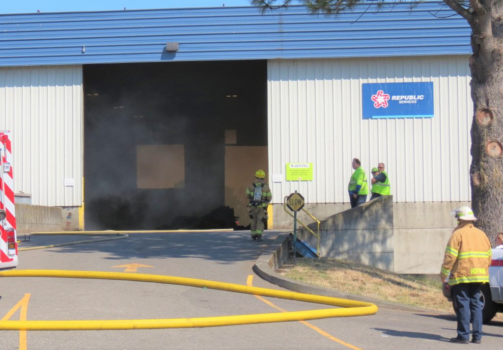 Workers stand by while firefighters from WCFD7 control a fire inside the Republic Services waste disposal center (July 23, 2019). Photo: My Ferndale News