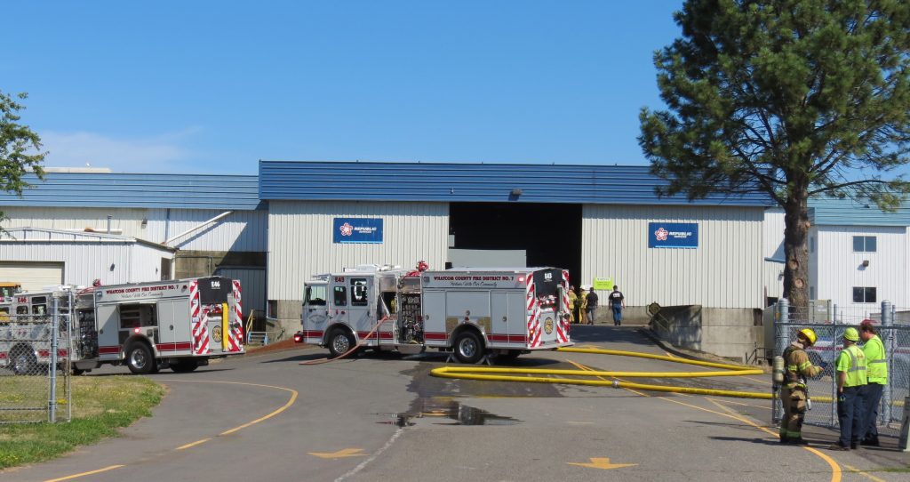 Workers stand by while firefighters from WCFD7 control a fire inside the Republic Services waste disposal center (July 23, 2019). Photo: My Ferndale News