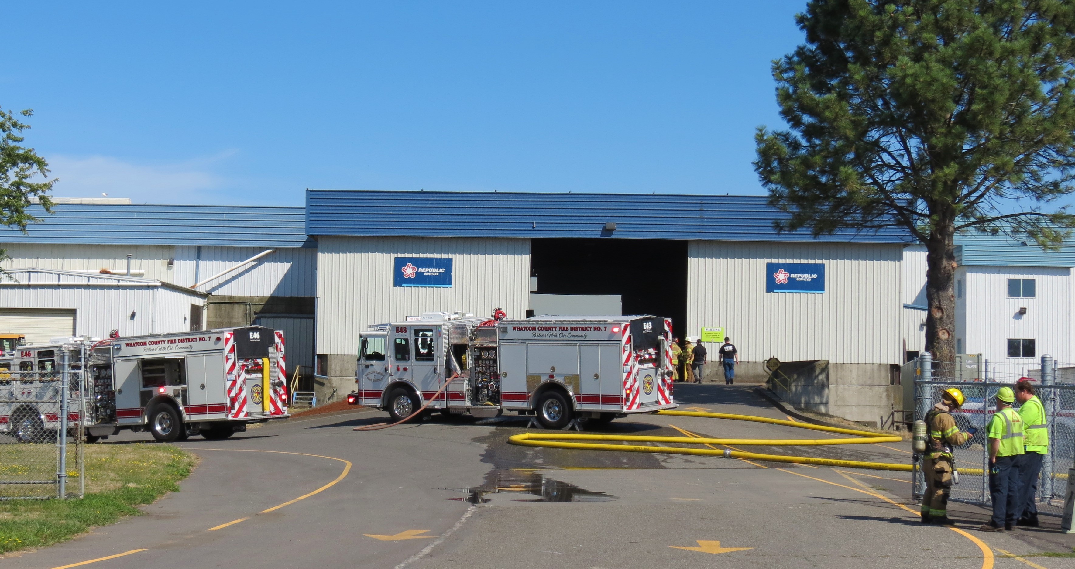 Workers stand by while firefighters from WCFD7 control a fire inside the Republic Services waste disposal center (July 23, 2019). Photo: My Ferndale News