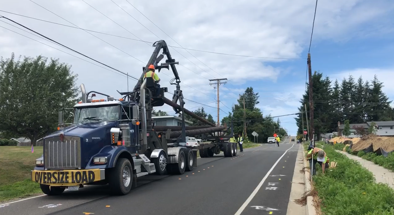 PSE crews unload new utility poles to be used to relocate utilities before the Thornton Street project can begin (July 15, 2019) Photo: City of Ferndale