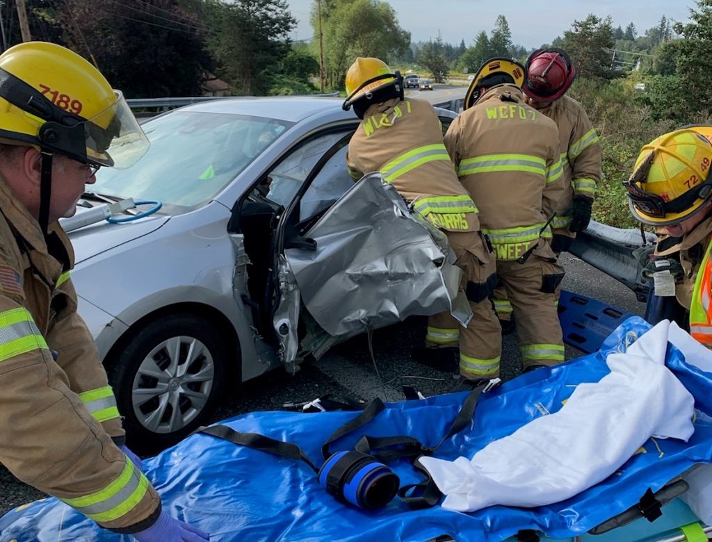 WCFD7 firefighters work to extricate a driver at the scene of a 2-vehicle crash at Pacific Highway and W Smith Road (August 16, 2019). Photo courtesy of WCFD7
