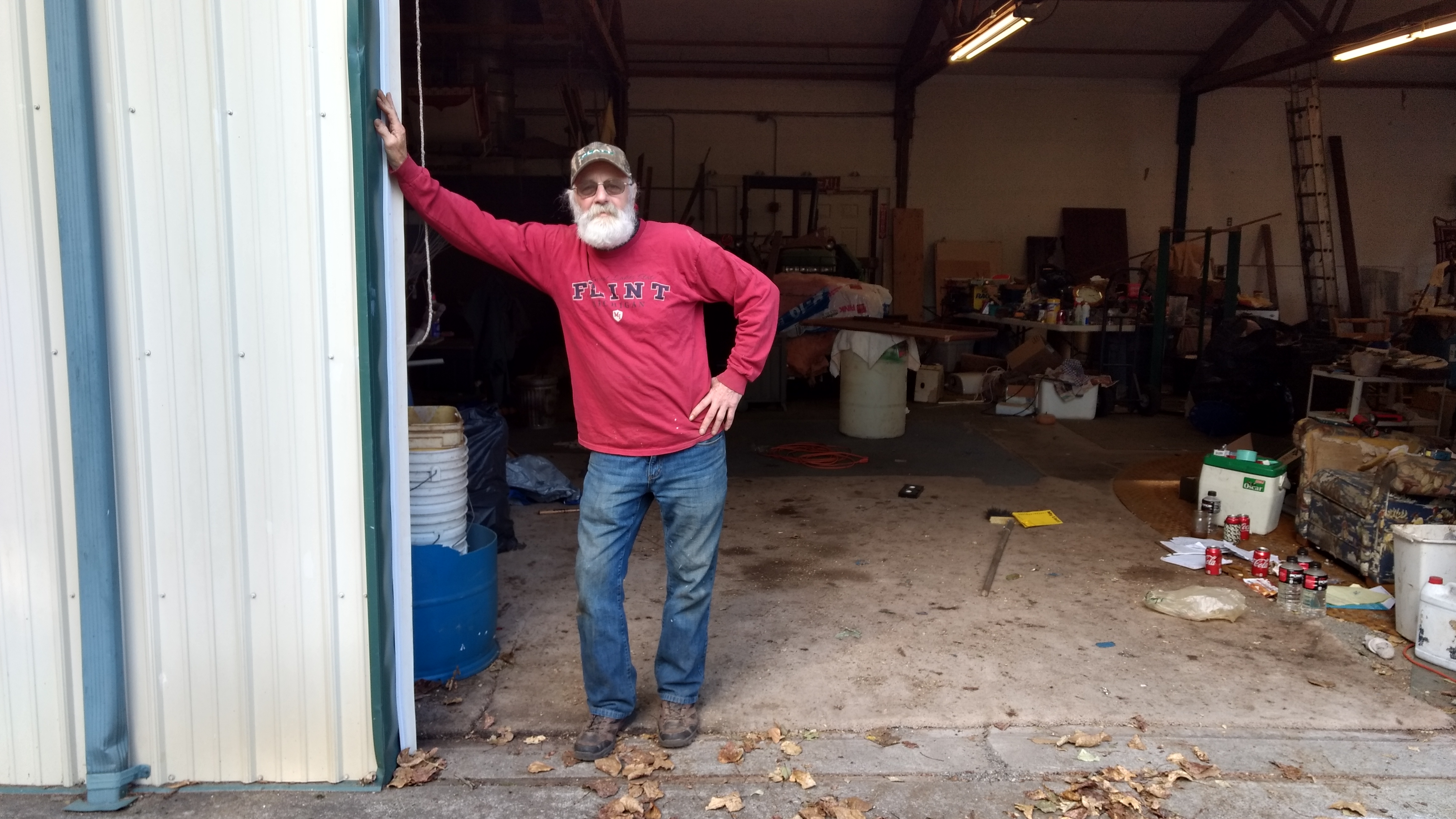 Kelly Sullivan stands in a roll-up door way at his business, The Strip Shop, on Portal Way (October 14, 2019). Photo: My Ferndale News