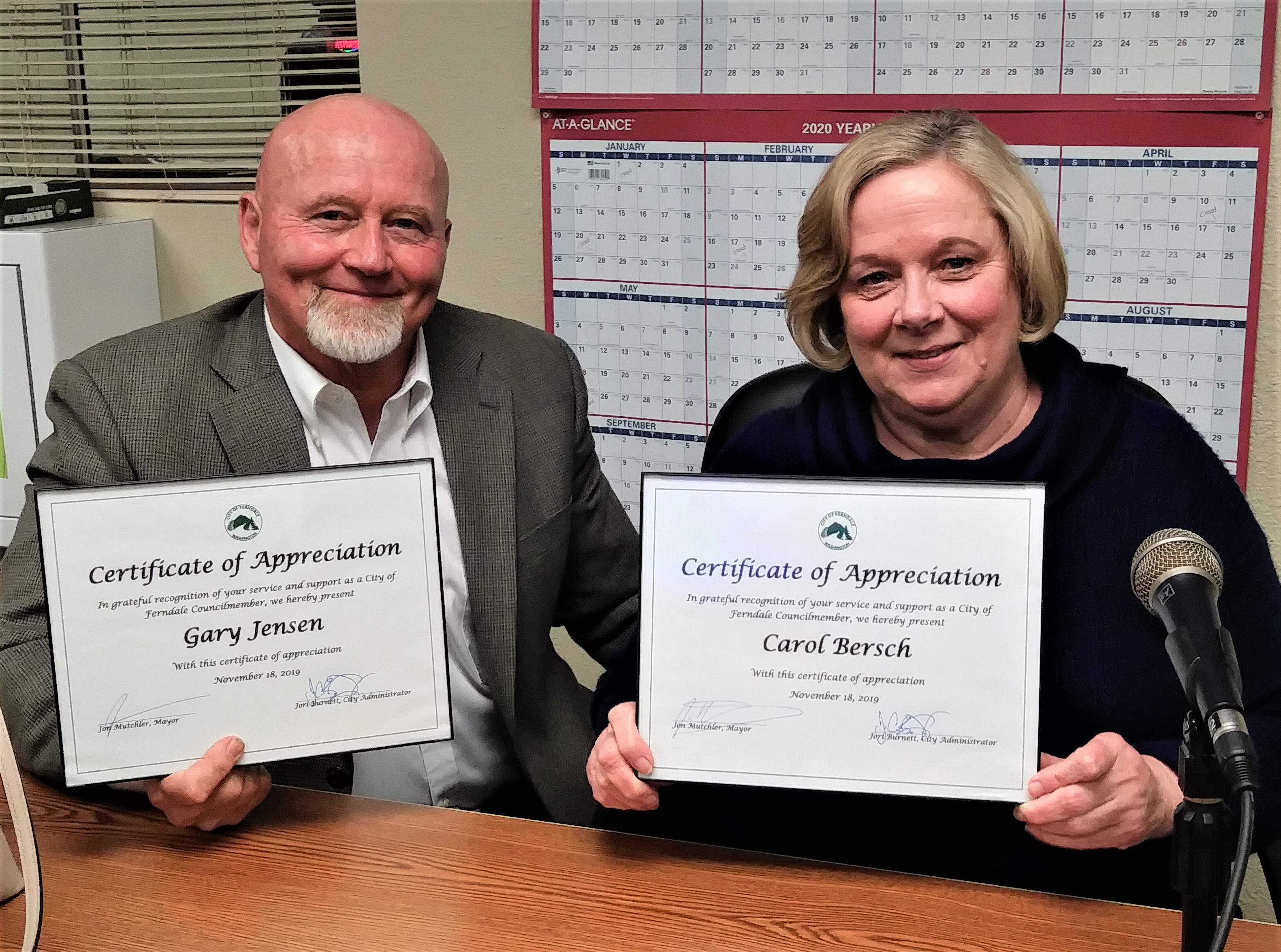 Gary Jensen and Carol Bersch pose with appreciation certificates received from the City for filling in on City Council for a few months (November 19, 2019). Photo: Ben O'Brine