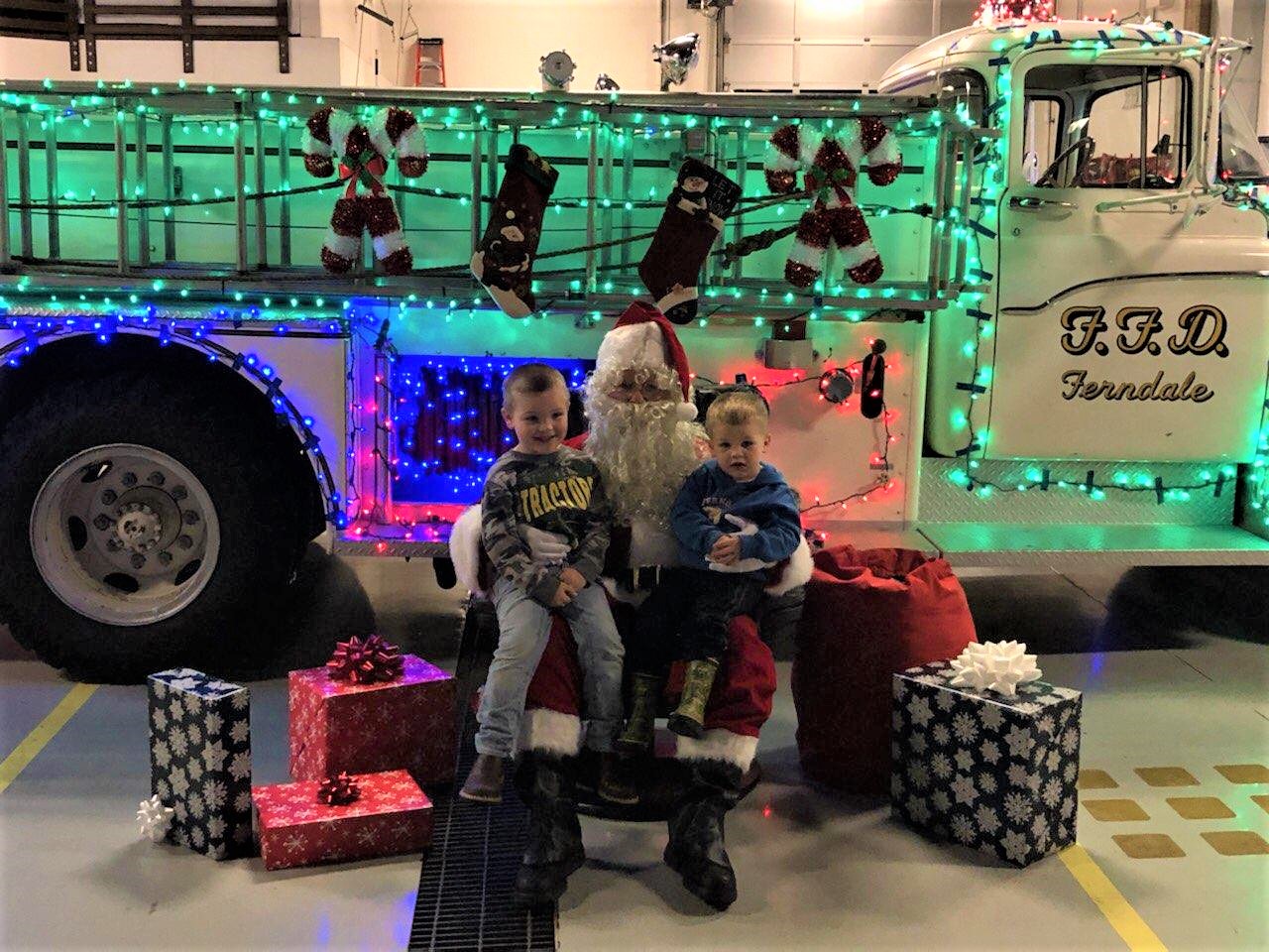 Santa poses with a couple visitors at the Washington Street Fire Station (December 6, 2019). Photo courtesy of WCFD7