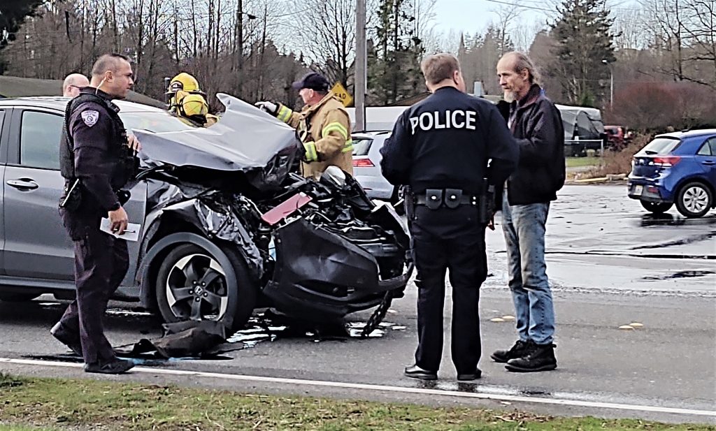 Ferndale Police interview a witness while WCFD7 personnel aid a driver at the scene of 2-vehicle crash on Portal Way at Newkirk Road (January 5th, 2020). Photo: My Ferndale News
