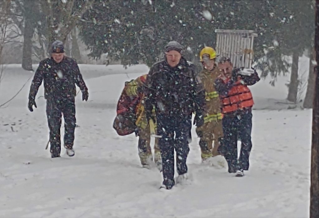 WCFD7 Fire Chief Larry Hoffman and other firefighters head back to their vehicles after rescuing a dog from the Nooksack River at VanderYacht Park (January 16, 2020). Photo: My Ferndale News