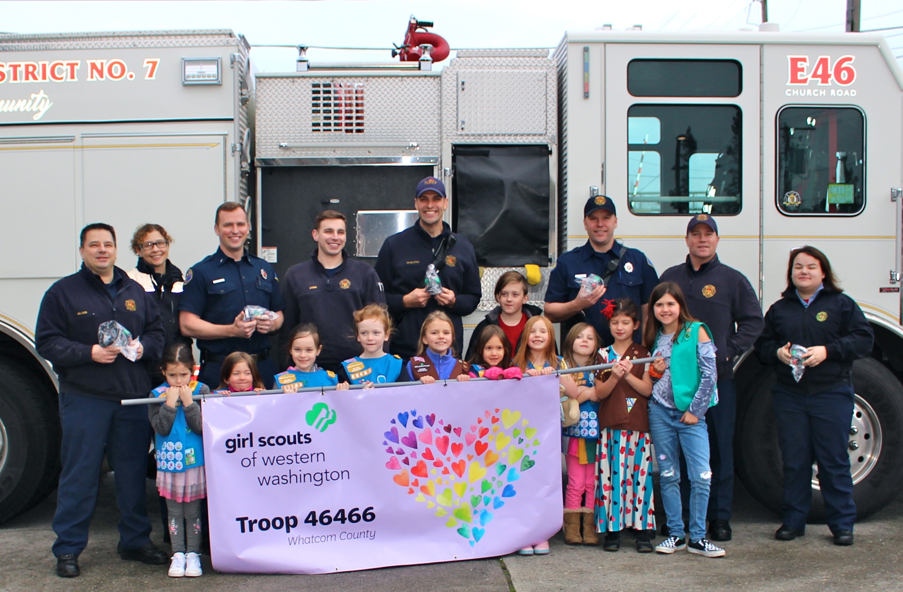 Girl Scouts Troop 46466 pose with WCFD7 firefighter/EMTs and firefighter/medics after donating snout-shaped oxygen masks (January 11, 2020). Photo courtesy of Bonnie Meyers.