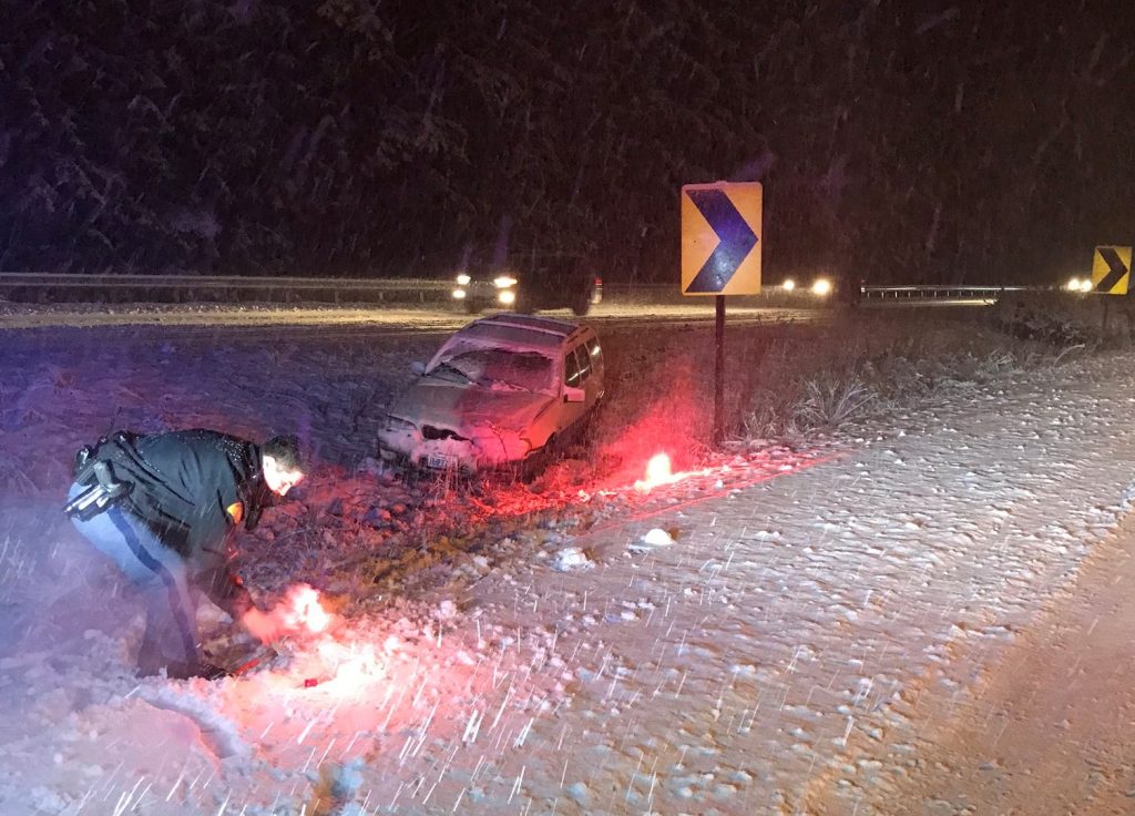 Washington State Patrol trooper tends to flares near a single-vehicle crash near milepost 246 on I-5 (January 12, 2020). Photo courtesy of WSP via Twitter