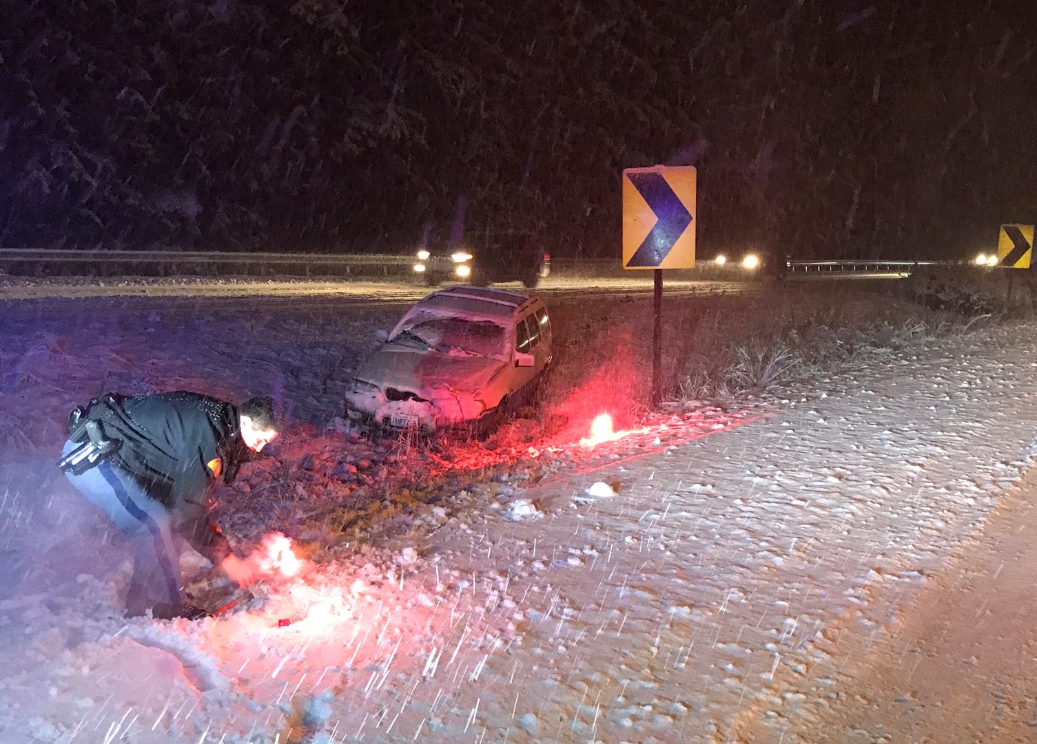 Washington State Patrol trooper tends to flares near a single-vehicle crash near milepost 246 on I-5 (January 12, 2020). Photo courtesy of WSP via Twitter