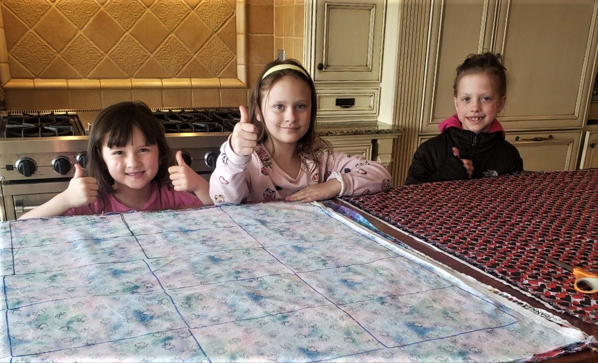 Helpers pose with several bolts of fabric donated by Portal Way Church of Christ to be used to make masks. Photo courtesy of Jolene McMillan of Ferndale