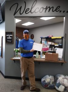 Ferndale Laundry Co-Owner Mike Cox poses with bags of fabric destined to be made into face masks by Ferndale area volunteer sewists (March 25, 2020). Photo courtesy Kim Brunelle Kuehnel