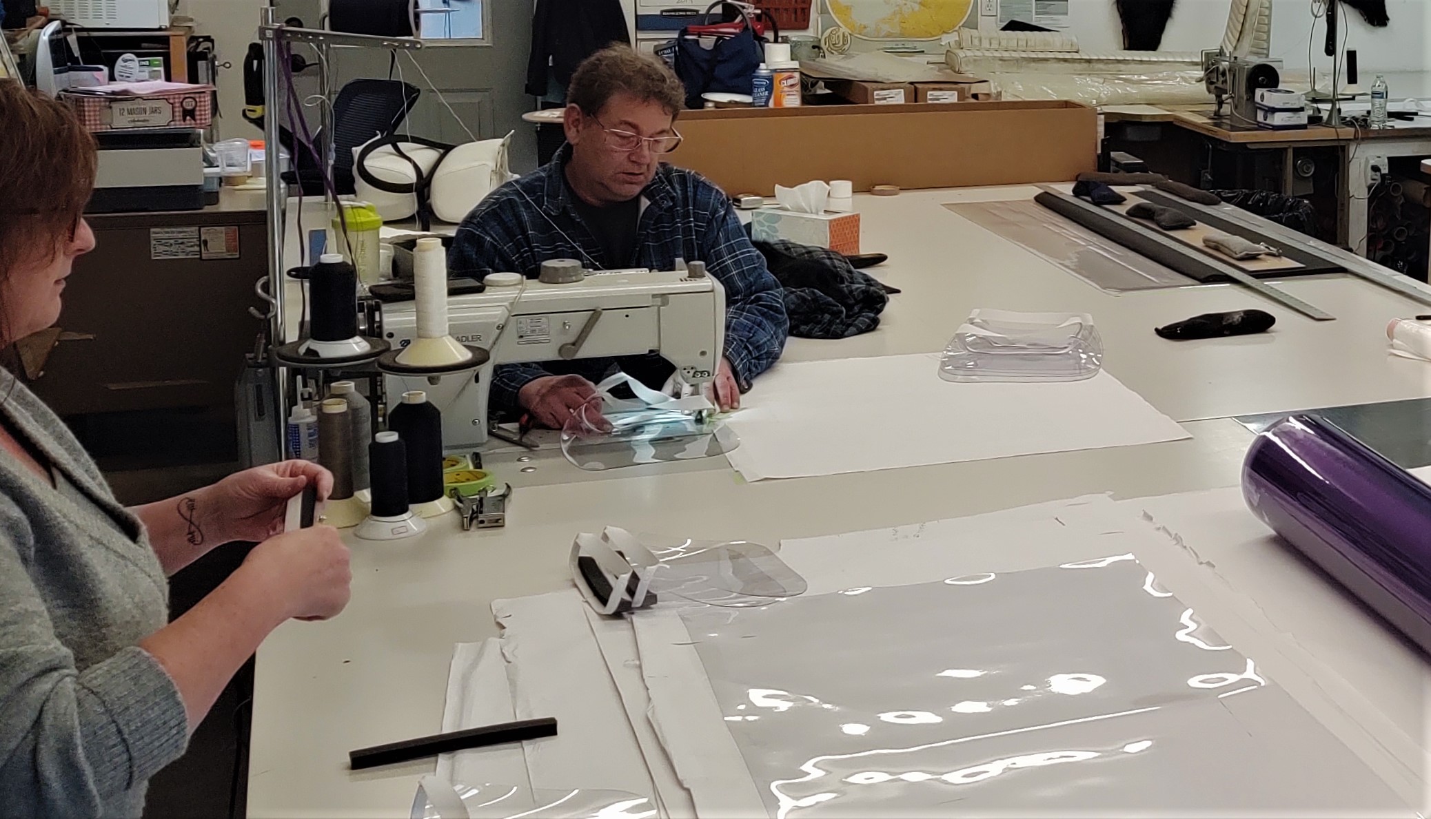 Renee Westhoff and Rob Gilmore are seen in Gilmore's Upholstery shop making face shields for front line workers during the COVID-19 pandemic (March 27, 2020). Photo: My Ferndale News