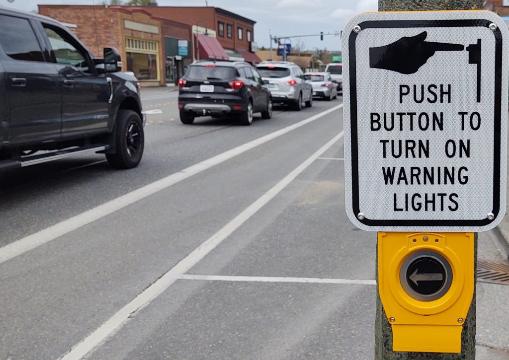 Activator button and instructions with a rectangular rapid flash beacon (RRFB) mounted on a light pole at 1st Avenue and Main Street (April 24, 2020). Photo: My Ferndale News
