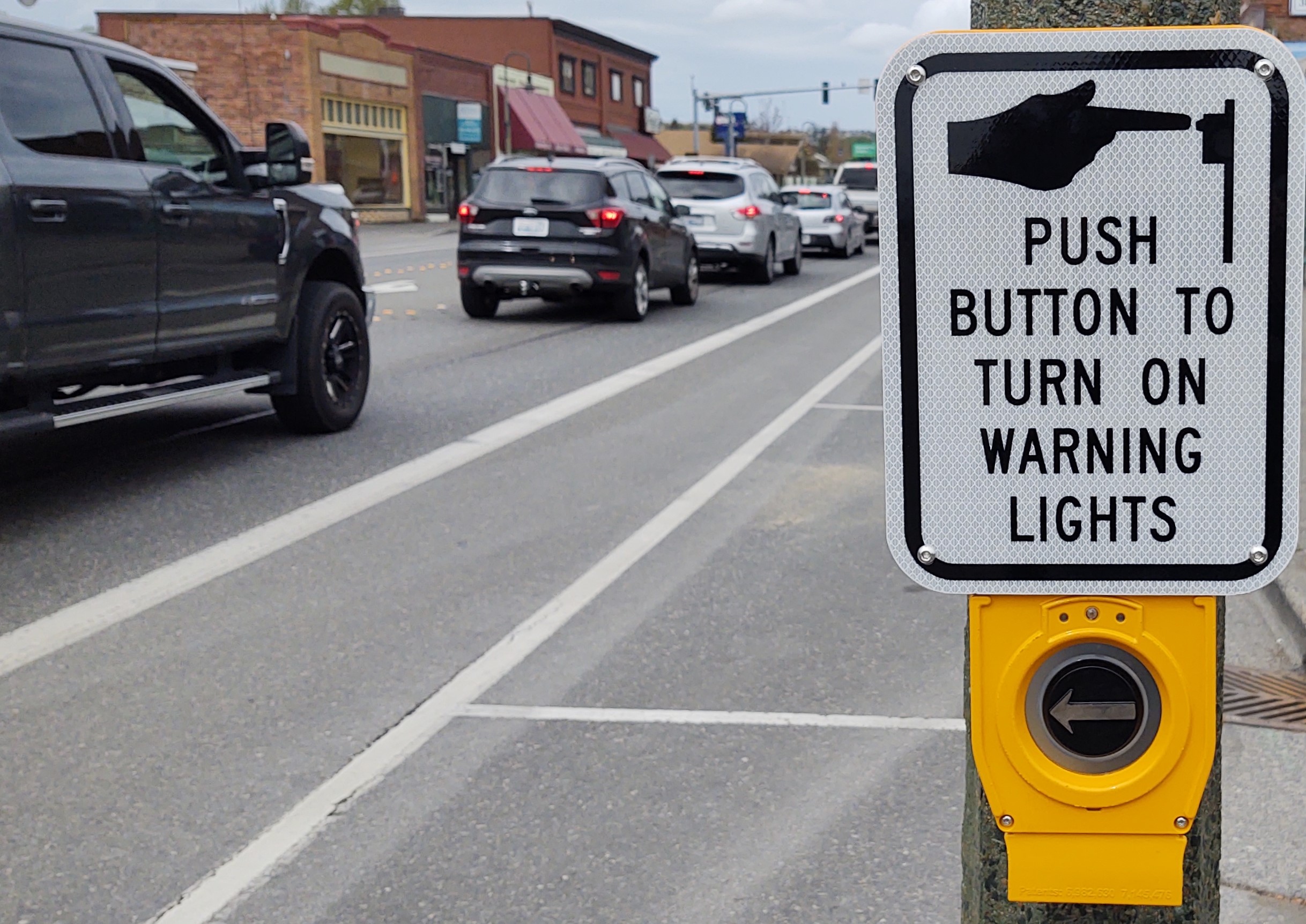Activator button and instructions with a rectangular rapid flash beacon (RRFB) mounted on a light pole at 1st Avenue and Main Street (April 24, 2020). Photo: My Ferndale News